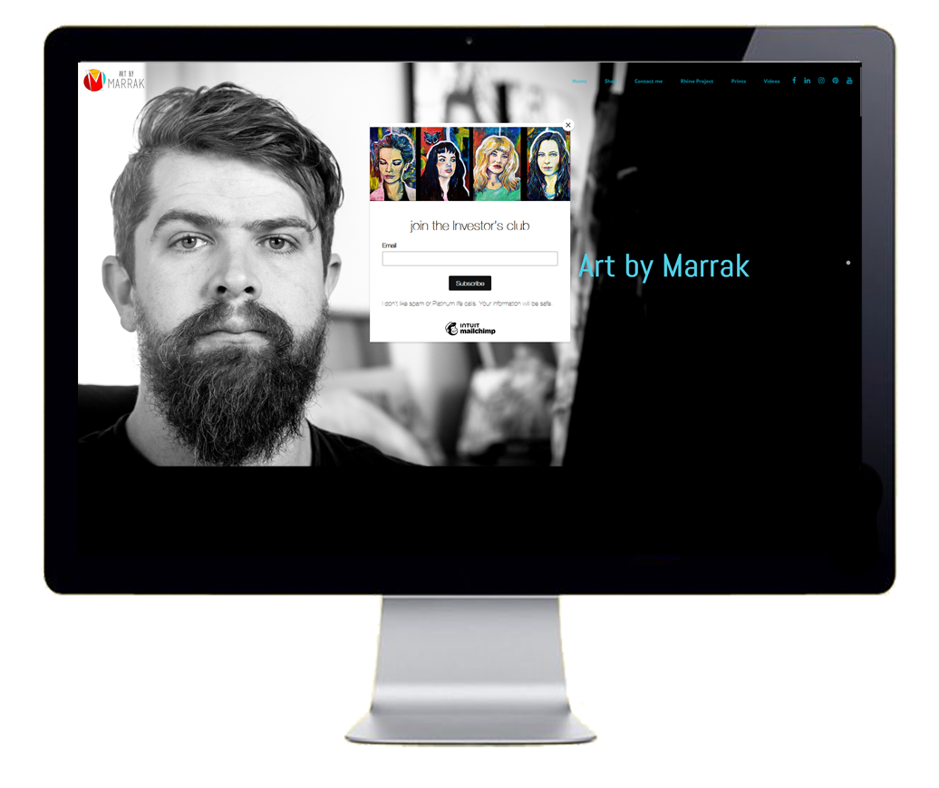 A computer monitor showcasing the homepage of www.marrak.co.za featuring a monochrome portrait and vibrant art with a subscription call-to-action.